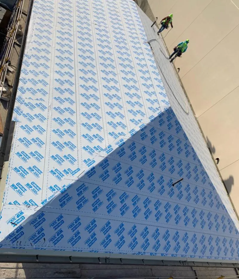 Professional roofers installing underlayment on a metal roof in Suisun City